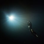 Free diver swimming to the light