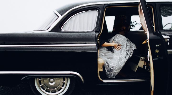 Woman in black vintage car